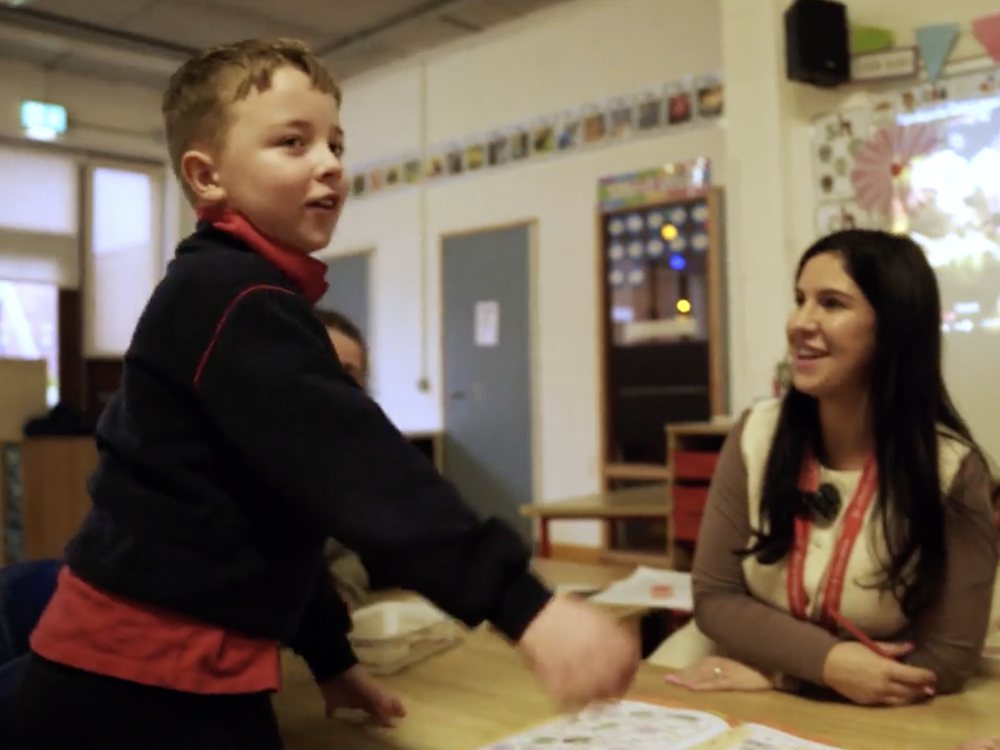 A St Ultan's teacher supporting a pupil in the classroom